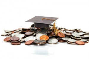 graduation cap  on a pile of money ( student debt )