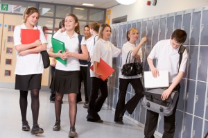 High school students by lockers in the school corridor